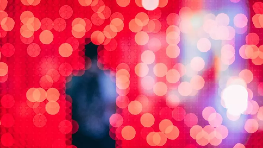 Silhouette of a person over a red background