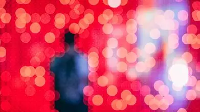 Silhouette of a person over a red background